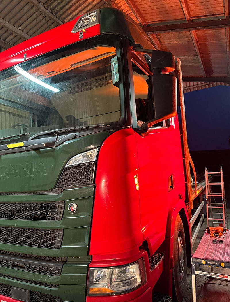 Fleet lorry being masked for full colour change wrap in workshop