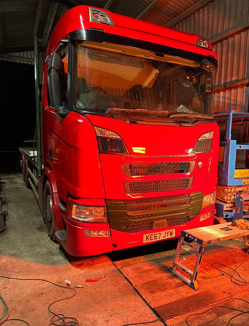 Lorry cab after commercial wrap installation – red gloss finish