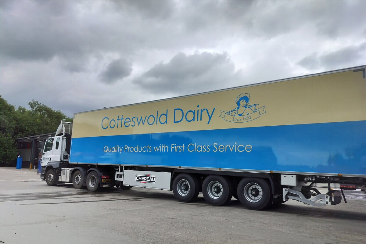 Yellow dairy lorry with blue Goldsands Dairy branding graphics