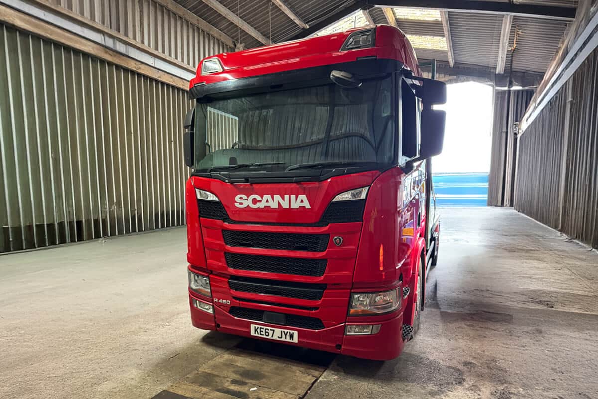 Red Scania truck wrapped for commercial logistics fleet branding UK