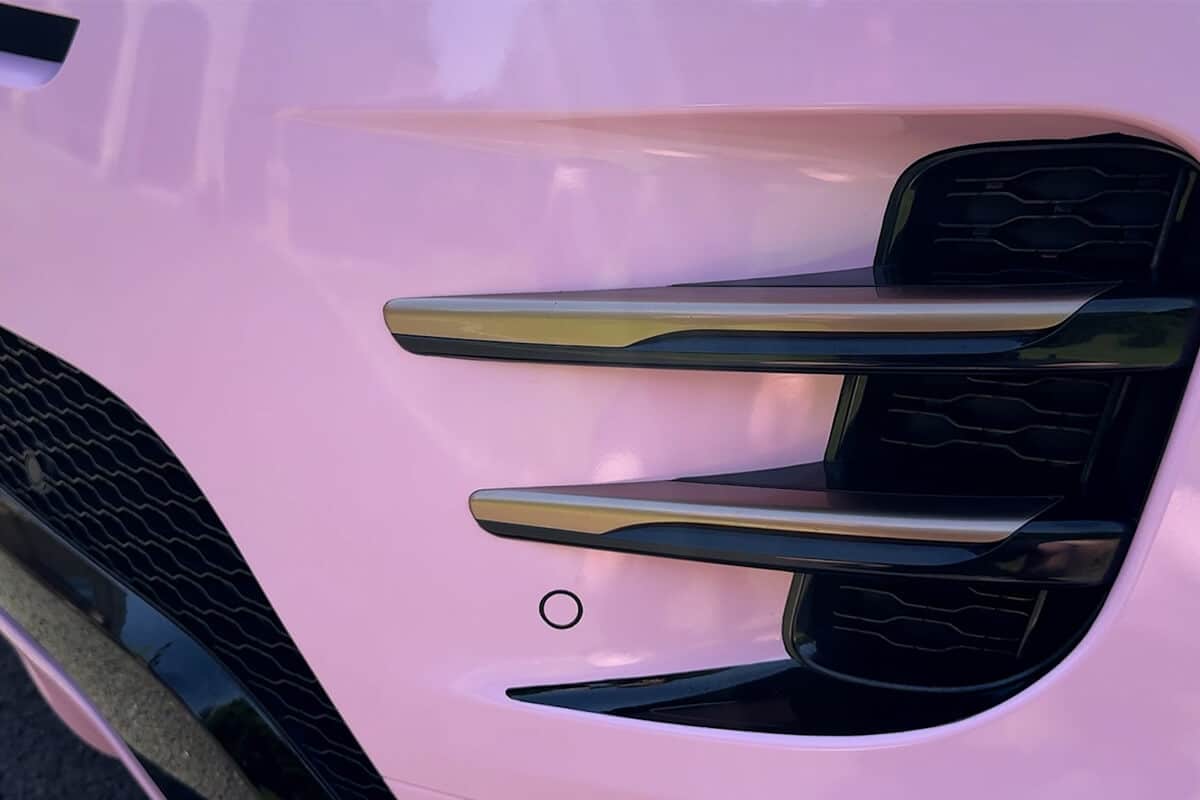 Close-up of pink Range Rover door detailing high-quality wrap installation