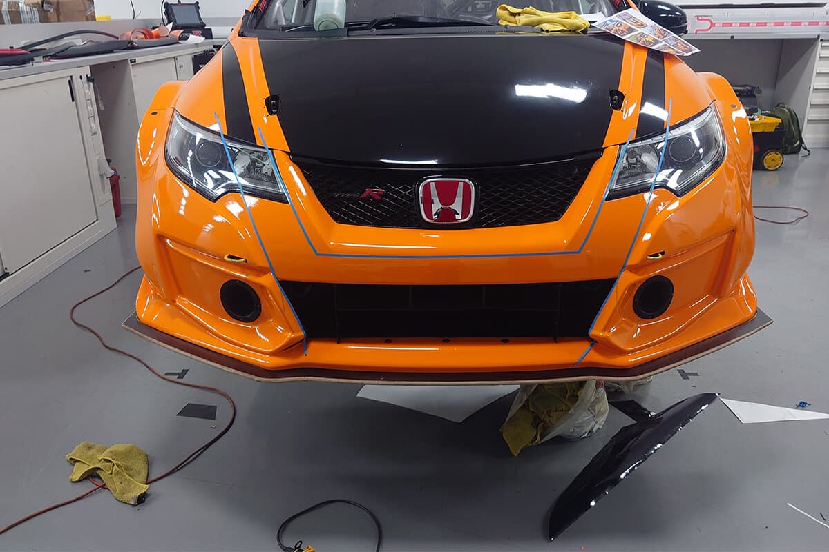 Motorsport car wrap featuring Halfords Yuasa Racing graphics