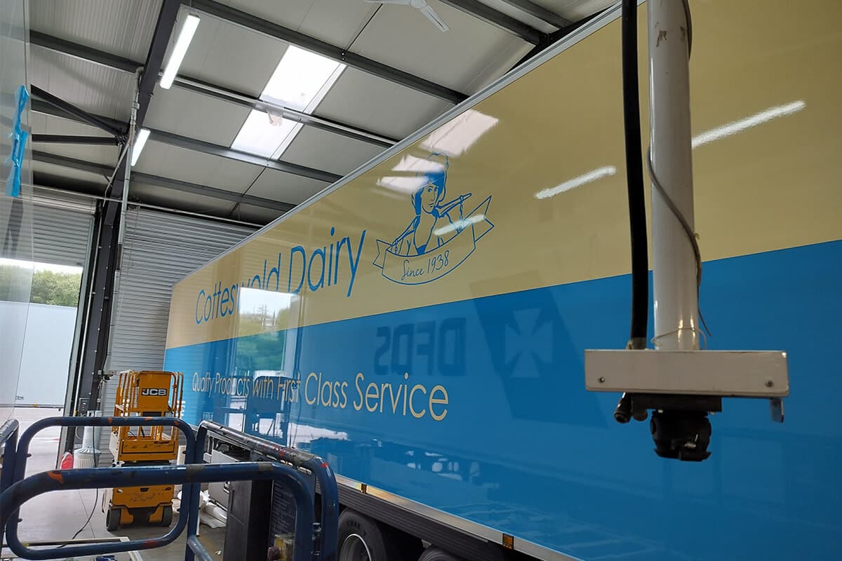 Close-up of refrigerated trailer wrap installation, showcasing exact colour matching to fleet livery.