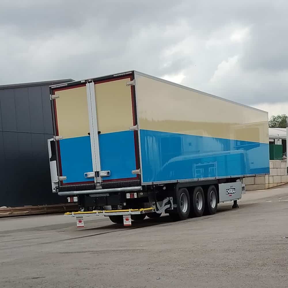 Rear view of refrigerated trailer with perfectly matched vinyl wrap for consistent fleet appearance.